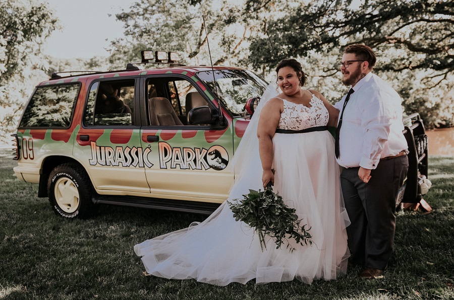 Courtney McMillion and Billy McMillion wedding ceremony photo near themed decorated Jeep